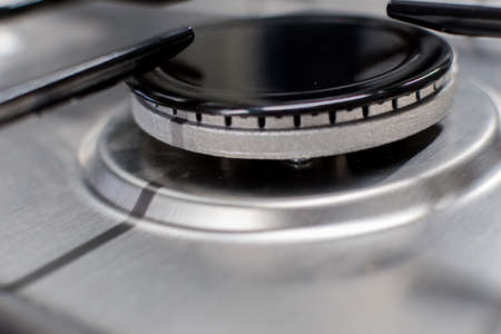 Close up shot of rapid burner on stainless steel gas hob with thin bar pan supportsの写真素材