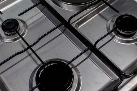 Close up shot of rapid burner on stainless steel gas hob with thin bar pan supportsの写真素材