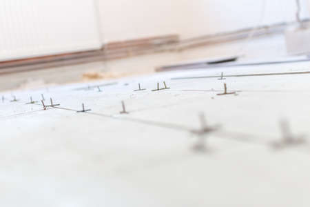 Close up shot of unfinished floor tiles installation in kitchenの写真素材
