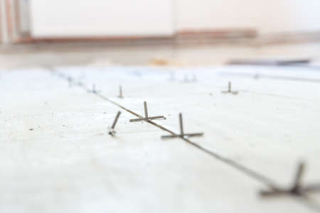 Close up shot of unfinished floor tiles installation in kitchenの写真素材