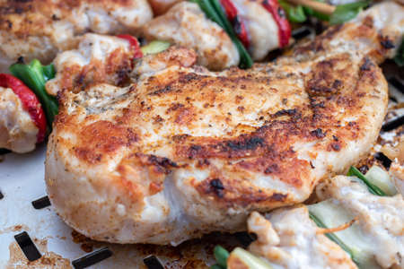 Chicken breast and pork meat pulled in wooden skewer with fresh colorful and tasty vegetables