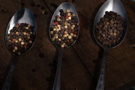 Various colored pepercorns on a dark background