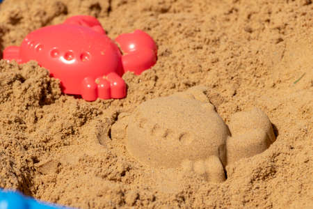 Plastic molds used by children to create different animals and shapes in the sand boxの写真素材