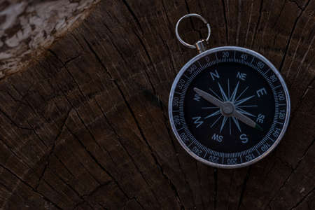 Close up shot of a silver metal compass always pointing it's needle towards Northの写真素材