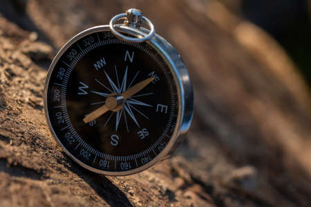 Close up shot of a silver metal compass always pointing it's needle towards Northの写真素材