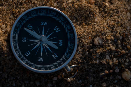 Close up shot of a silver metal compass always pointing it's needle towards Northの写真素材