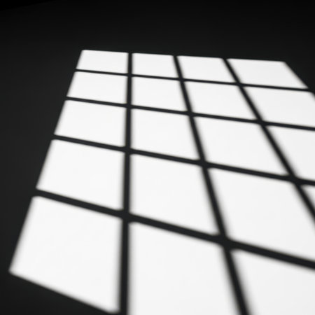 A close-up view of an abstract light grid pattern projected onto a dark background, creating a striking contrast and geometric design.の素材