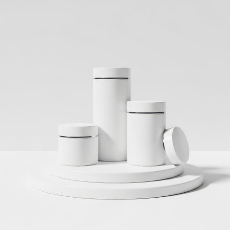 This image features a minimalist collection of white ceramic objects, including a tall vase, a medium-sized vase, a small cup, and a plate. The objects are arranged on a white pedestal, all set against a transparent background. The design is clean and modern, emphasizing simplicity and elegance.の素材