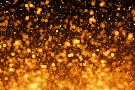 Abstract gold bokeh on black background. Christmas and New Year concept.の素材