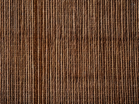 Closeup of a brown thread on a wooden background. Abstract background for design.の素材