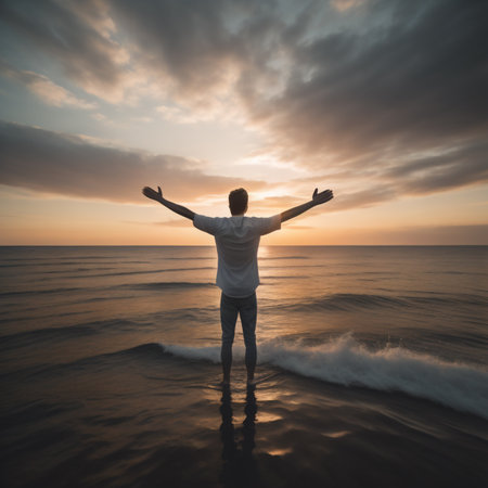 Man with open arms on the seashore at sunset background.の素材
