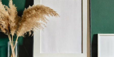 Blank white paper with dry pampas grass in vase on tableの素材