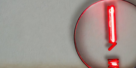 Red neon tube on concrete wall background. Red light sign with copy space.の素材