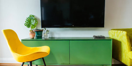 Interior of modern living room with yellow sofa and TV on wallの素材