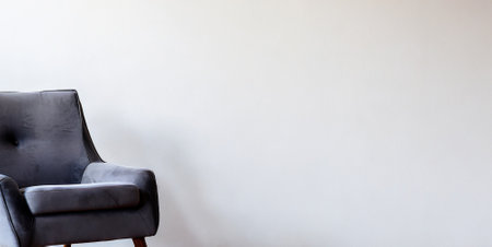 Black leather armchair on white wall background with copy space for textの素材