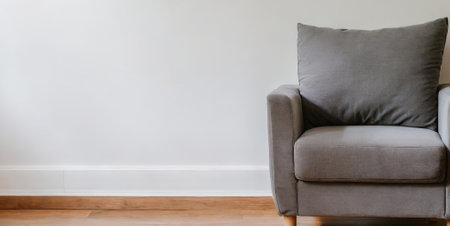Interior of living room with grey armchair and white wall.の素材