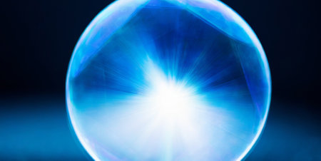 crystal ball with rays of light on a dark blue background.の素材