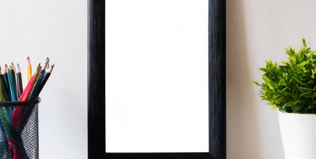 Blank picture frame with pencils in black holder on white backgroundの素材