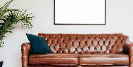 Brown leather sofa in living room with white mock up poster frame.の素材