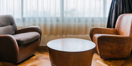 Cozy living room with two brown leather armchairs and coffee tableの素材