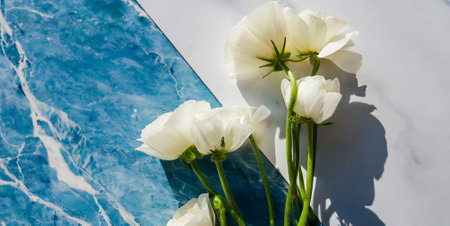 White flowers on the background of the blue water. Wedding concept.の素材