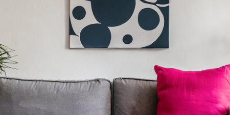 Living room interior with sofa, pillows and abstract painting on wallの素材