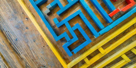 Colorful wooden maze on a wooden floor, closeup of photoの素材