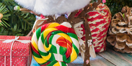 Lollipops in the form of a Christmas tree on a wooden backgroundの素材