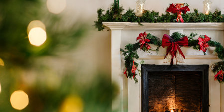 Christmas and New Year holidays background. Fireplace with burning candles, Christmas tree branches and giftsの素材