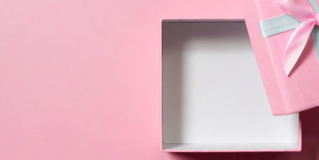 Pink gift box on pink background with copy space, top view.の素材