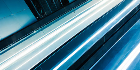 abstract background of moving escalators in modern business center,blue tonedの素材
