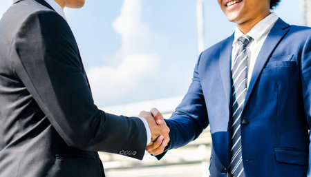 Business people handshaking after good deal. Business people shaking hands, finishing up a meeting.の素材