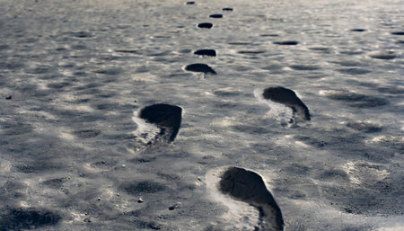 Footprints in the snow, close up of footprints on the groundの素材
