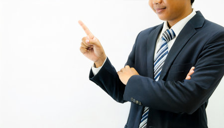 Businessman pointing with his finger on white background, business concept.の素材