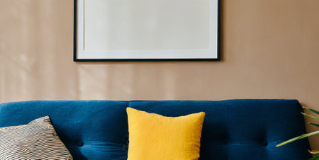 Close up of blue sofa with yellow pillows in living room.の素材