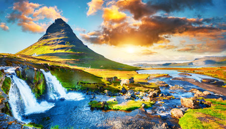 Famous Kirkjufellsfoss waterfall in Iceland at sunsetの素材