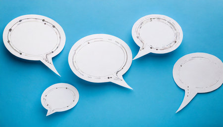 white paper with speech bubbles isolated on blue background communication bubblesの素材