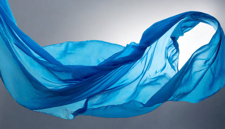 Smooth elegant blue cloth flying in the wind, on gray backgroundの素材