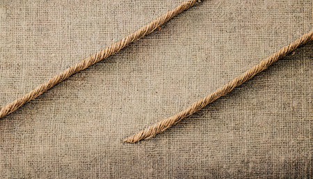 Burlap texture with two ropes as background, closeup viewの素材