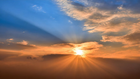 sun rays on sunset sky with blue ond orange colorful sunset cloudsの素材