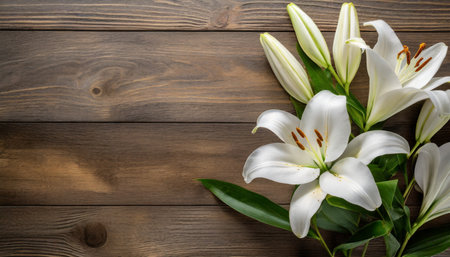 white lily flowers on wooden background top view with copy space funeral conceptの素材