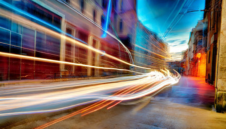 light trails on the street at night in lisbon portugalの素材