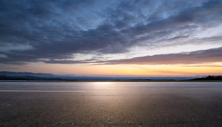 Asphalt road and sky with clouds at sunset,panoramic viewの素材