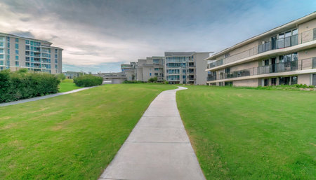 Panorama of a residential area with a walkway leading to an apartment buildingの素材