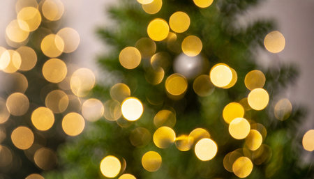 christmas tree bokeh light in green yellow golden color holiday abstract background blur defocusedの素材