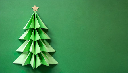origami green christmas fir tree on green plain background paper craft minimal winter holiday concept copy space greeting cardの素材