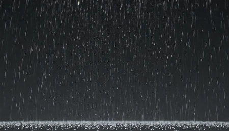 falling raindrops footage animation in slow motion on black background black and white luminance matte rain animation with start and end perfect for film digital composition projection mappingの素材