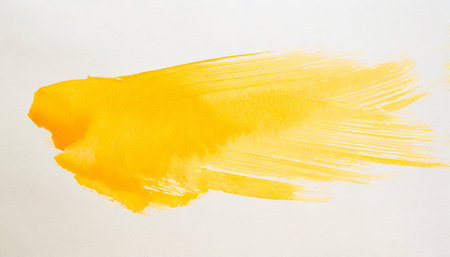 yellow stroke of watercolor paint brush on white backgroundの素材
