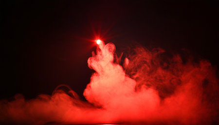 artificial magic smoke in red light on black backgroundの素材
