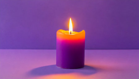 purple candle on a purple background a bright orange lightの素材